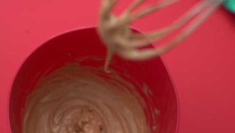Close-up-of-delicious-home-made-ice-cream-dripping-from-a-whisk-while-mixing