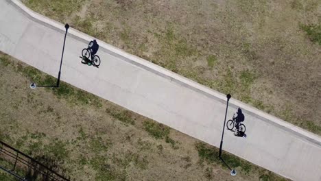 aerial-footage-of-two-cyclists-on-an-asphalt-road