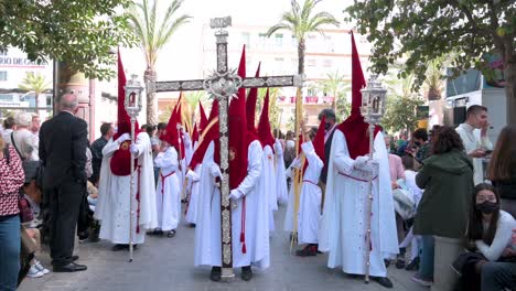 Penitents-march-during-a-procession-as-they-celebrate-the-Holy-Week-in-Cadiz,-Spain
