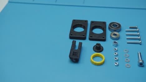 Pan-Left-Small-Parts-Prepared-For-Assembly-Blue-Background