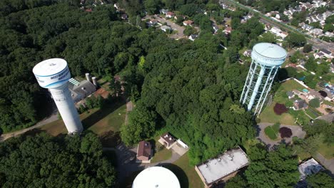 A-high-angle-view-over-water-towers-in-a-suburban-neighborhood-on-Long-Island,-NY-on-a-sunny-day