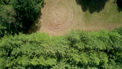 Christian-Labyrinth-meditation-forest-garden-oasis,-aerial-drone-view-from-above