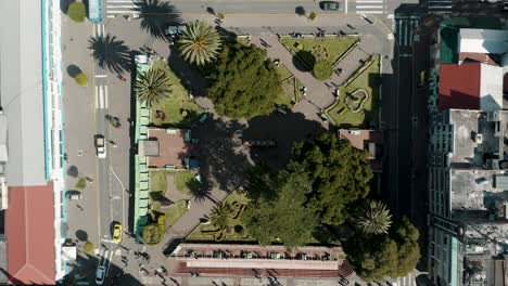 Overhead-View-Of-Parque-La-Basilica-And-Vehicles-Driving-In-The-Street-At-Baños-De-Agua-Santa,-Ecuador