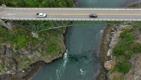 Overhead-drone-shot-of-cars-commuting-over-the-Deception-Pass-steel-bridge