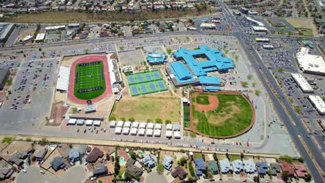 Drone-Aerial-View-Flying-Circling-Above-High-School-Campus-In-West-El-Paso,-Texas-With-Football-Field-And-Baseball-Field-In-View