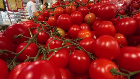 static-shot-of-full-racks-of-tasty-fresh-tomatoes-in-the-store-waiting-for-the-customer