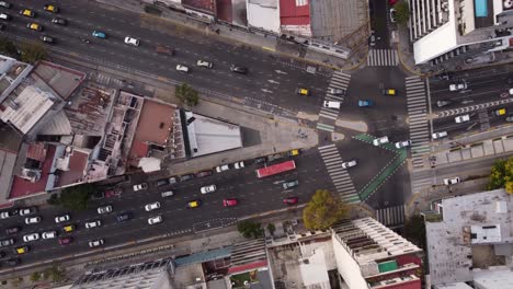 Drone-flying-over-urban-fork-in-Cordoba-Avenue,-Buenos-Aires-city-in-Argentina