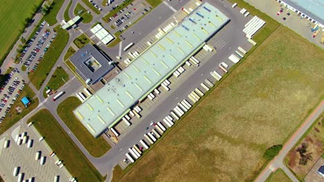 Aerial-view-of-warehouse-storages-or-industrial-factory-or-logistics-center-from-above
