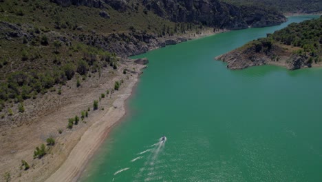 aerial-view-of-beautiful-landscape-of-greenish-reservoir-bordered-by-rocky-slopes-in-sunny-day