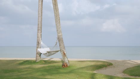 Luxury-beach-lounge-beds-with-umbrella-on-white-sand-beach