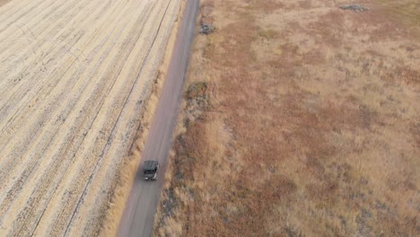 Ranger-Driving-Down-Dirt-Road-in-Utah-Mountains-in-the-Fall-During-Dusk-Top-Aerial-Drone-View-4K