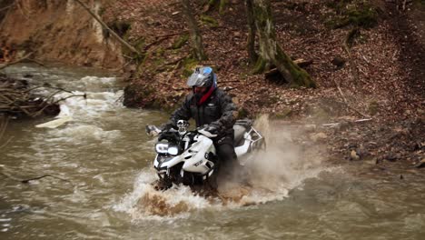 Off-Road-motorcycle-crossing-the-river-splashing-water-and-dirty-mud-Slow-Motion,-Extreme-Sport-Trial-powerful-Bike-rider-smoking-engine-in-the-wet-autumn-forest