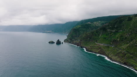 Aerial-along-Porto-Moniz-steep-and-rugged-rocky-coastline,-Madeira,-Portugal