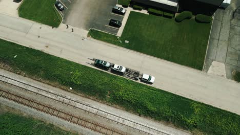 car-hauler-parked-next-to-railroad-4k-drone-footage