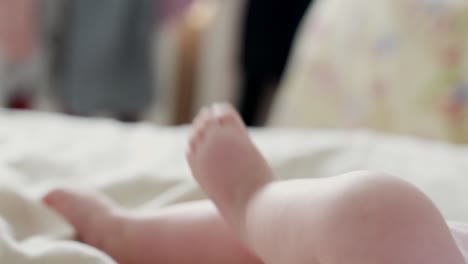 Close-up-to-cute-and-tiny-baby's-feet,-kicking-legs