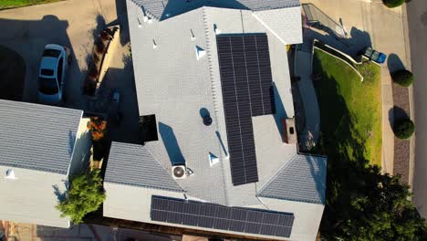 Topdown-view-modern-house-in-neighborhood-with-Solar-panel-rooftop,-Descending-aerial-shot