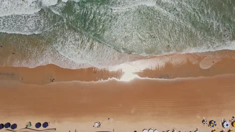 Topdown-upwards-waves-crashing-at-beach-shore,-Natal,-Brazilian-coastline