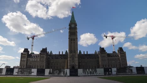 Parliament-of-Canada,-Centre-Block-under-renovation,-in-Ottawa-on-a-partly-cloudy-summer-day-before-Canada-Day---4K
