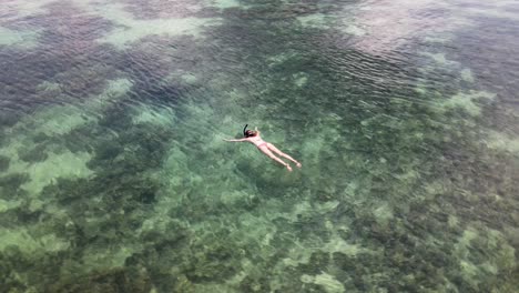 Aerial-View-Of-Female-Snorkelling-In-Waters-At-Koh-Lipe