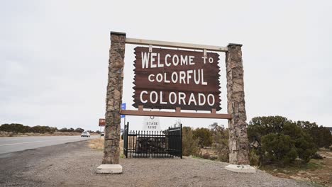 Welcome-to-Colorful-Colorado-state-line-sign-on-an-overcast-day,-static