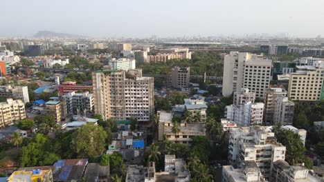 drone-shot-birds-eye-view-andheri-marol-metro-station-train-side-view-Mumbai-India-wide-angle-green-city