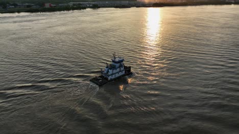 Aerial-view-of-a-push-boat-on-the-Mississippi-River-at-sunset