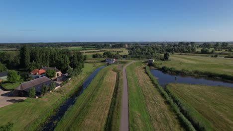 Pumping-station-part-of-water-management-in-Dutch-river-valley-landscape-at-the-end-of-meandering-embankment-with-in-the-distance-the-ruins-remains-of-Nijenbeek