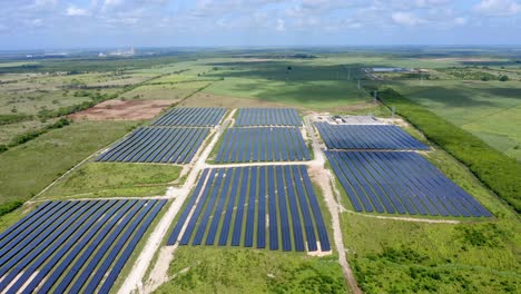 Aerial-drone-flyback-pov-of-El-Soco-solar-photovoltaic-park-of-San-Pedro-De-Macoris-in-Dominican-Republic