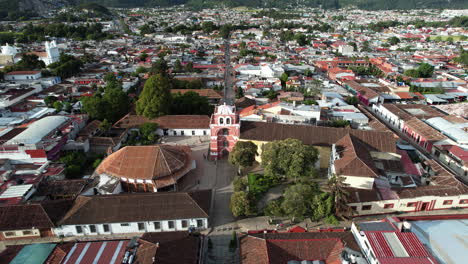 Orbital-drone-shot-showing-the-Moorish-style-arch-of-the-city-of-San-Cristobal-de-las-Casas-in-Chiapas-Mexico