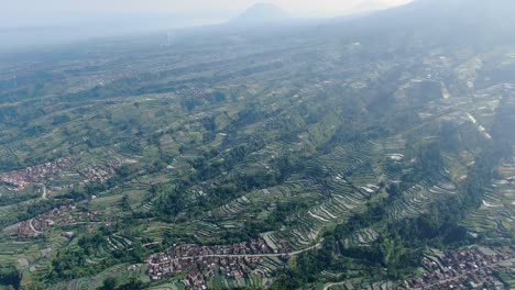 Terraced-farmlands-and-Wonolelo-village-on-Mount-Merapi-volcano-slope,-Indonesia