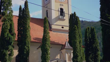 Pan-up-camera-movement-revealing-a-church-with-a-clock-tower-at-Brasov-Romania