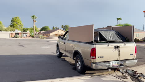 Ford-pickup-truck-drives-off,-towing-U-Haul-trailer