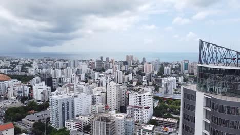 Santo-Domingo,-Dominican-Republic---July-2022-:-Drone-flight-over-downtown-with-cityscape-views