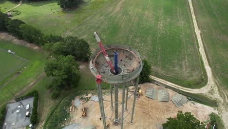 Epic-fly-over-rotating-drone-shot-of-a-water-tower-under-construction