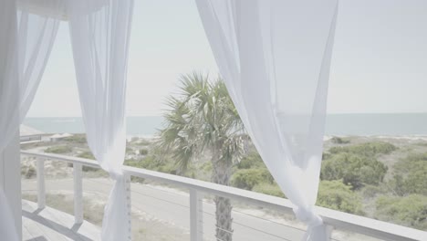 Idyllic-wedding-venue-location-looking-through-curtains-to-seafront