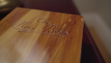 Close-up-dolly-across-wooden-book-box-labeled-The-Holy-Bible