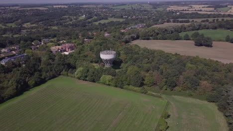Drone-aerial-view-orbiting-water-tower-in-Trent-Park-North-London-UK