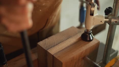 Close-Up-Shot-of-a-Carpenter-Using-a-Drill-to-Work-on-a-Piece-of-Wood