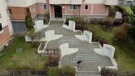 Wide-Aerial-Shot-of-a-Young-Adult-Male-Parkour-Free-Runner-Jumping-Walls-in-a-Unique-Location