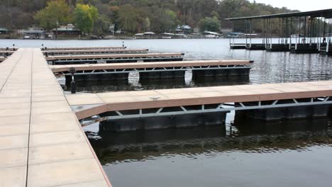 Empty-floating-dock-on-a-lake-with-no-filled-slips-on-a-cloudy-day