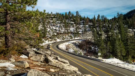 Winter-holiday-traffic-timelapse-in-the-Sierra-Nevada-mountains-along-curvy-and-windy-Highway-50-near-Lake-Tahoe,-California