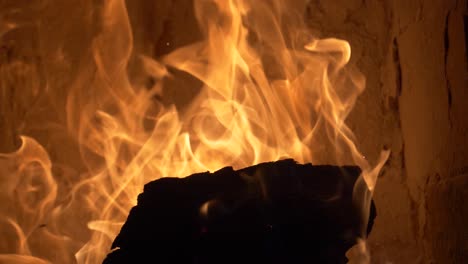 Firewood-burning-in-a-tile-stove-180-fps-slow-motion---tilt-up