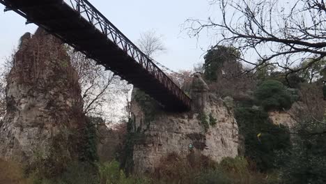 bridge-in-the-Buttes-Chaumont-park-in-Paris,-viewed-from-under-in-grey-weather