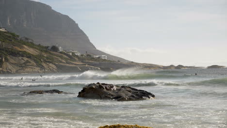 Surfers-riding-waves-in-Cape-Town-South-Africa-at-sunrise