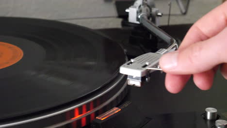 A-record-player-needle-raising-slowly-off-of-the-spinning-vinyl-and-the-music-stops