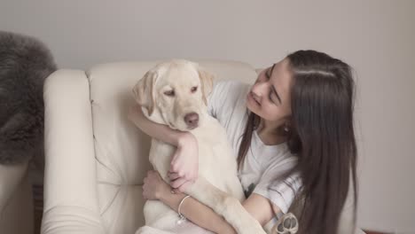 The-pretty-girl-talks-with-her-pet-that-is-a-labrador-retriever