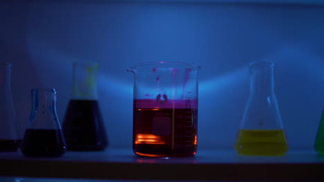 Tracking-Shot-of-Beakers-in-a-Dark-Lab