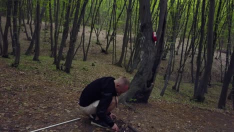 Man-making-firecamp-in-the-forest