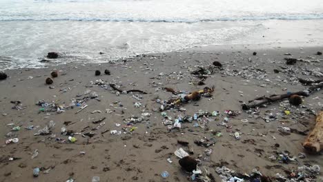 Camera-moves-over-plastic-garbage-washed-out-to-the-shore-from-the-ocean,-man-kind-polluted-the-seas