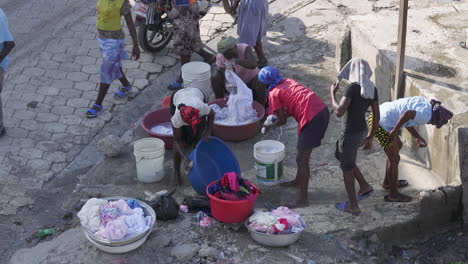 Women-washing-clothes-on-the-street-in-a-Petion-Ville-neighborhood